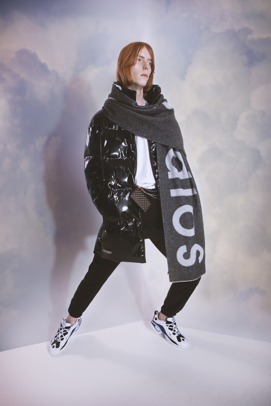 A model standing in front of a cloud background