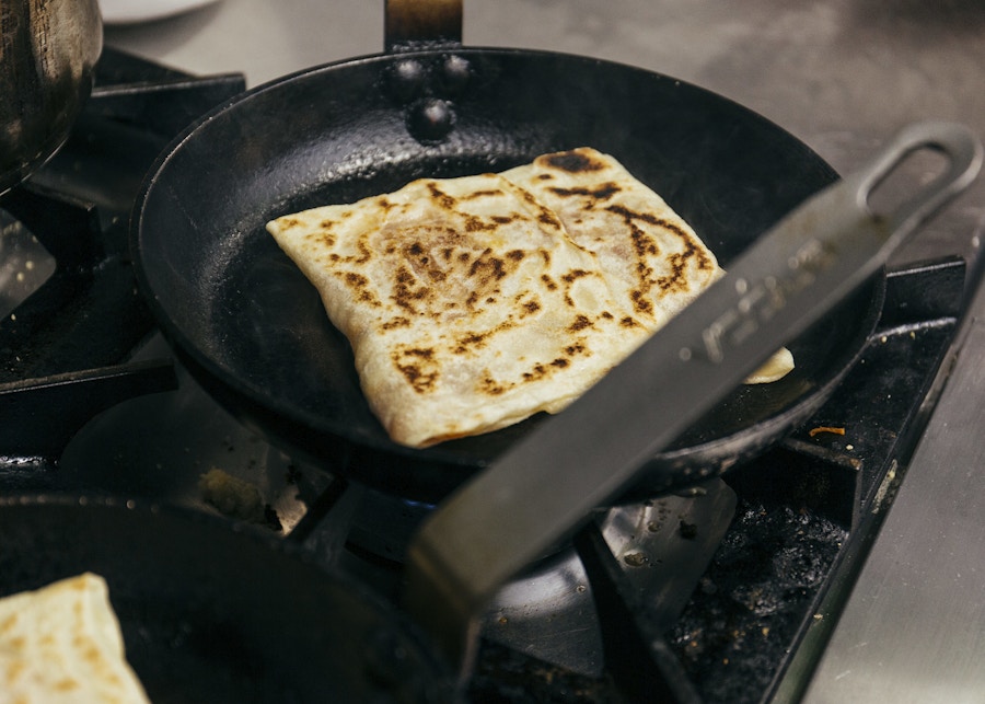 A crepe frying in a pan